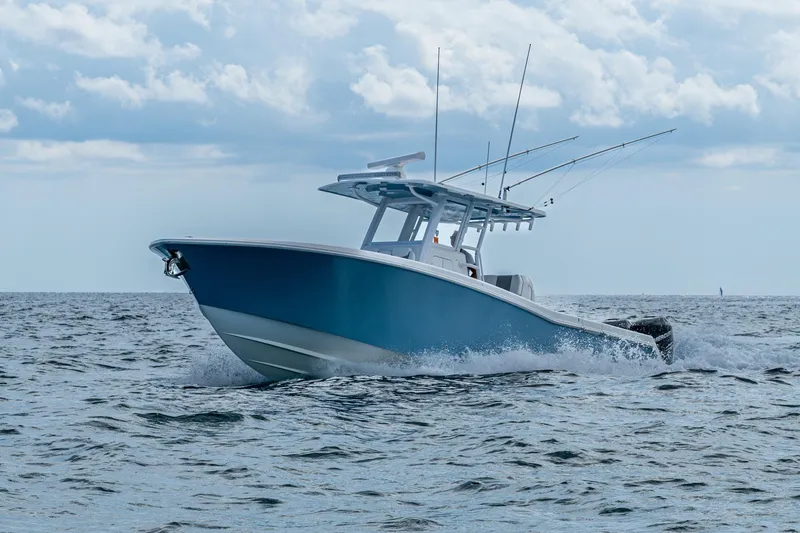 Slide: The Image of 2023 Invincible 36 Open Fisherman boat cruising on open water under cloudy sky. - 24