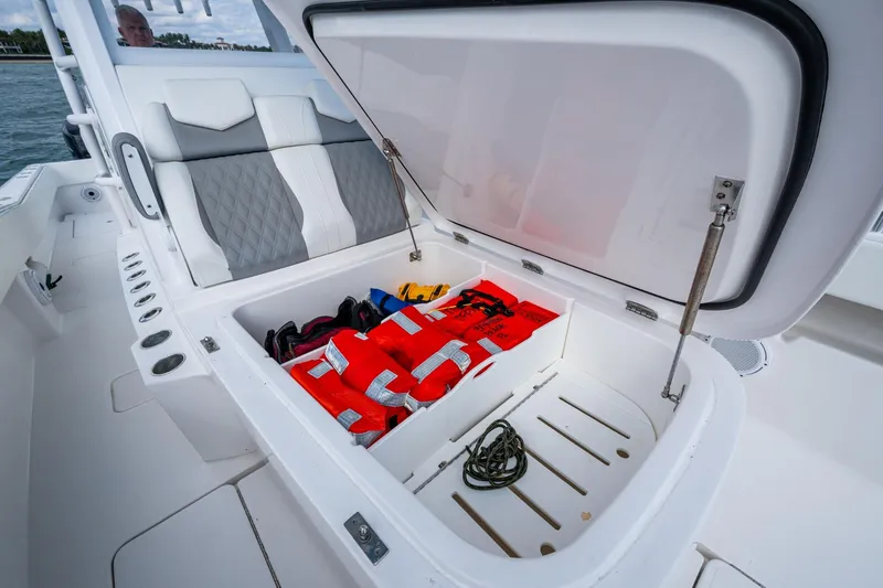 Slide: The Image of 2023 Invincible 36 Open Fisherman boat storage with life jackets and rope. - 26