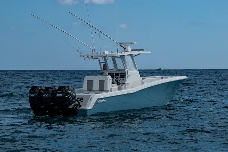 Slide: The Image of 2023 Invincible 36 Open Fisherman boat on open sea with triple engines. - 36