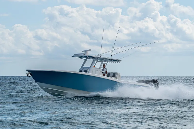 Slide: The Image of 2023 Invincible 36 Open Fisherman boat cruising on ocean waves under cloudy sky. - 38