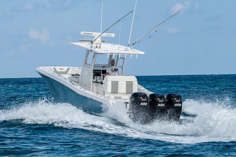 Slide: The Image of 2023 Invincible 36 Open Fisherman boat cruising on ocean with triple 400 engines. - 41