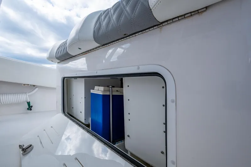 Slide: The Image of Storage compartment on 2023 Invincible 36 Open Fisherman boat, featuring cushioned seating. - 44