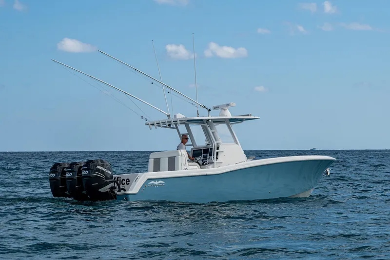 Slide: The Image of 2023 Invincible 36 Open Fisherman boat on the ocean with triple Mercury engines. - 48