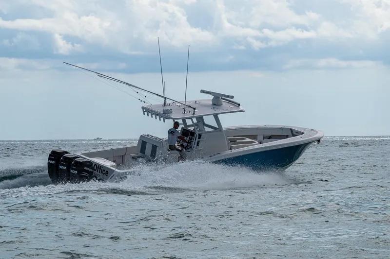 Slide: The Image of 2023 Invincible 36 Open Fisherman cruising on the ocean with triple outboard engines. - 49