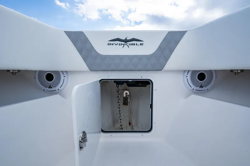 Slide: The Image of 2023 Invincible 36 Open Fisherman boat anchor compartment with speakers and logo. - 52