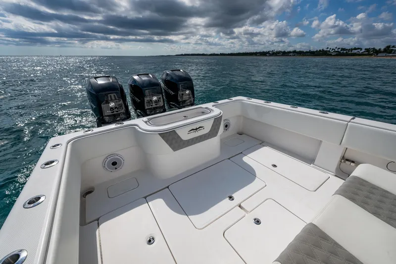 Slide: The Image of 2023 Invincible 36 Open Fisherman boat with triple outboard engines on open water. - 53