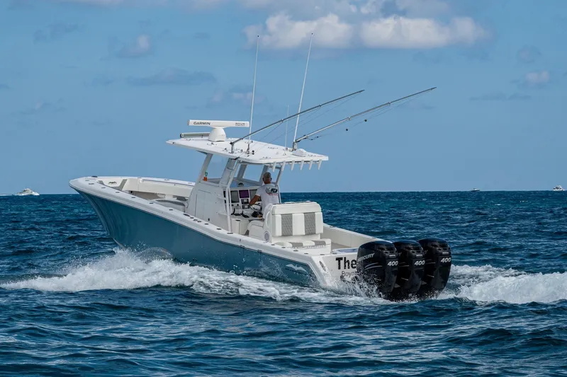 Slide: The Image of 2023 Invincible 36 Open Fisherman boat cruising on open water with triple engines. - 56