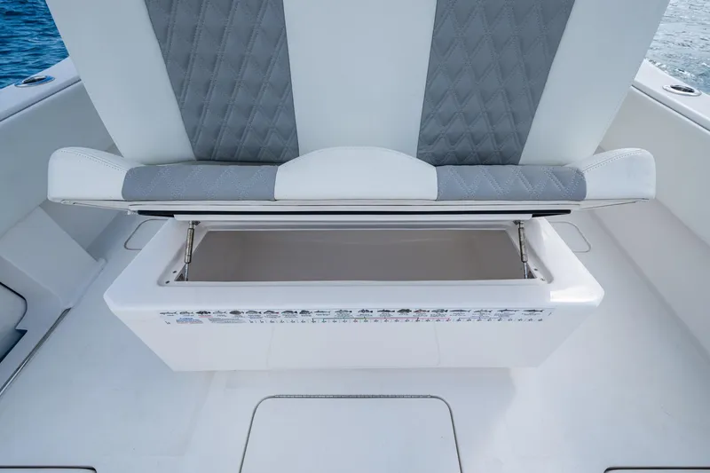 Slide: The Image of 2023 Invincible 36 Open Fisherman boat seat with storage compartment open. - 59