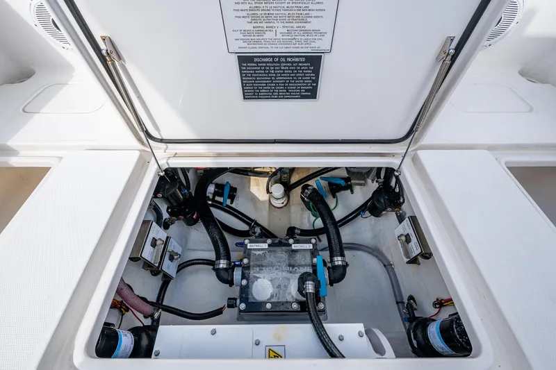 Slide: The Image of 2023 Invincible 36 Open Fisherman boat compartment with visible wiring and components. - 89