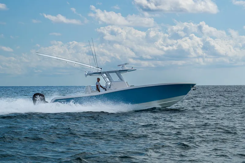 Slide: The Image of 2023 Invincible 36 Open Fisherman cruising on open water under a cloudy sky. - 96