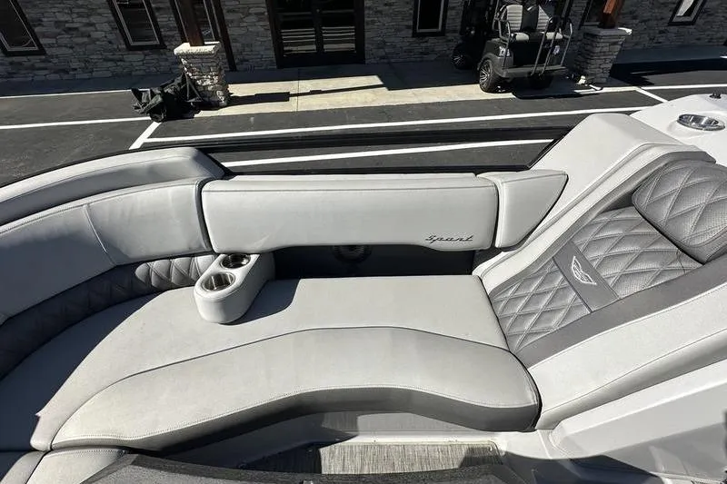 Slide: The Image of 2021 Bennington 24 RTFB boat interior with gray cushioned seating and cup holders. - 10