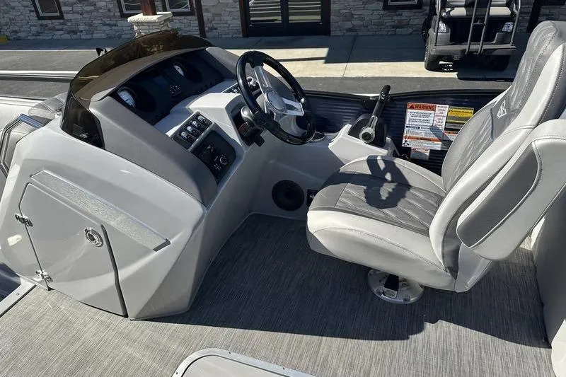 Slide: The Image of 2021 Bennington 24 RTFB boat interior with steering console and captain's chair. - 14