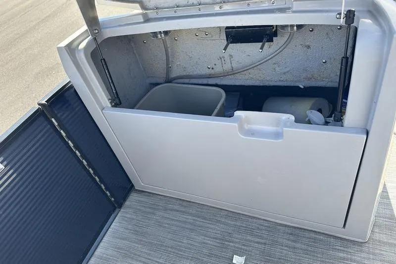 Slide: The Image of Open storage compartment on a 2021 Bennington 24 RTFB boat, showing interior details. - 15