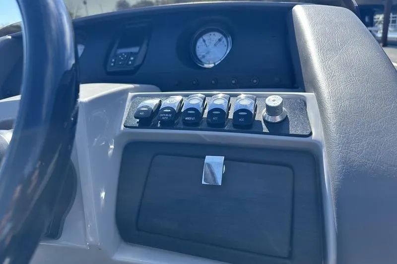 Slide: The Image of Dashboard controls of a 2021 Bennington 24 RTFB boat, featuring switches and a gauge. - 22