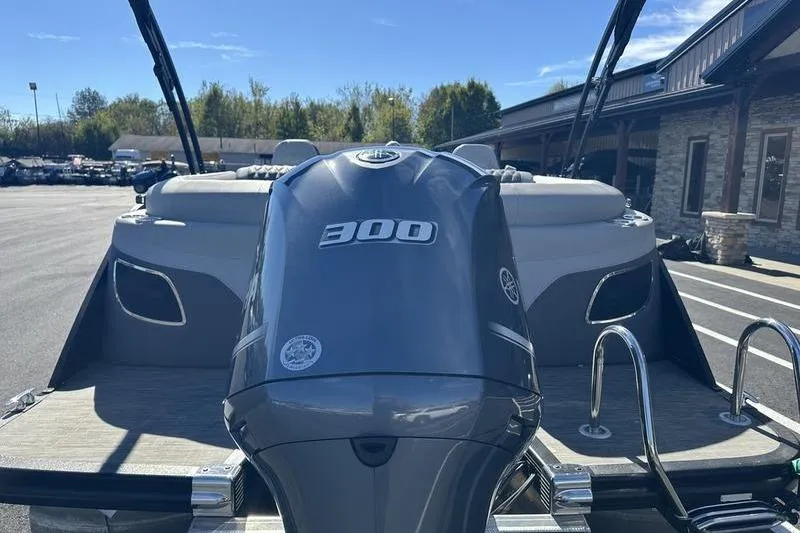 Slide: The Image of 2021 Bennington 24 RTFB boat with powerful 300 HP engine, parked outdoors. - 3