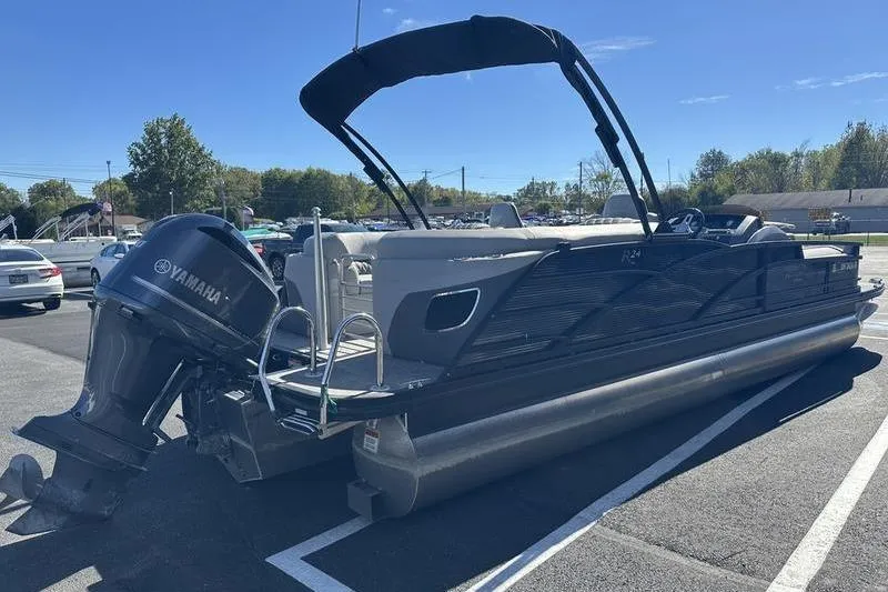 Slide: The Image of 2021 Bennington 24 RTFB pontoon boat with Yamaha outboard motor in a parking lot. - 4