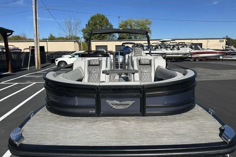 Slide: The Image of 2021 Bennington 24 RTFB pontoon boat with luxurious seating, parked in a marina. - 7