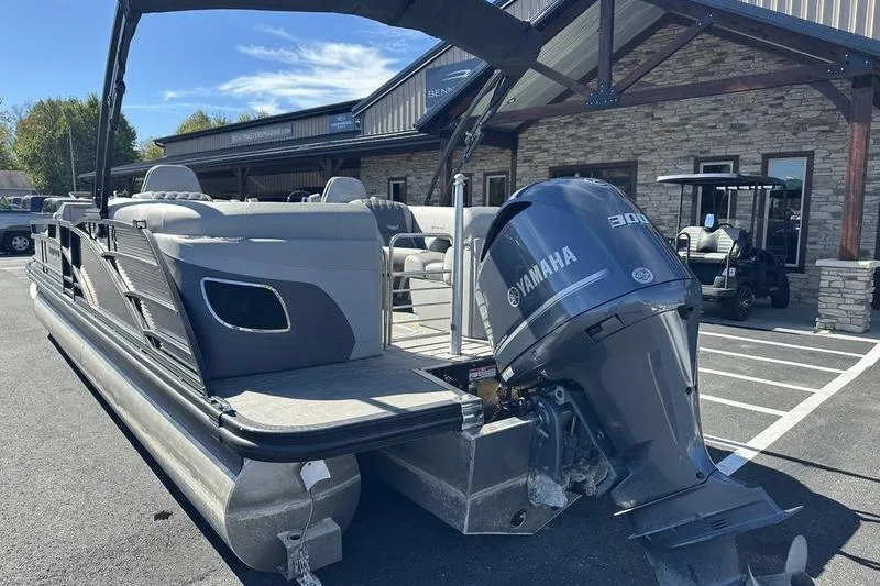 Slide: The Image of 2021 Bennington 24 RTFB pontoon boat with Yamaha 300 engine, parked outside a dealership. - 8