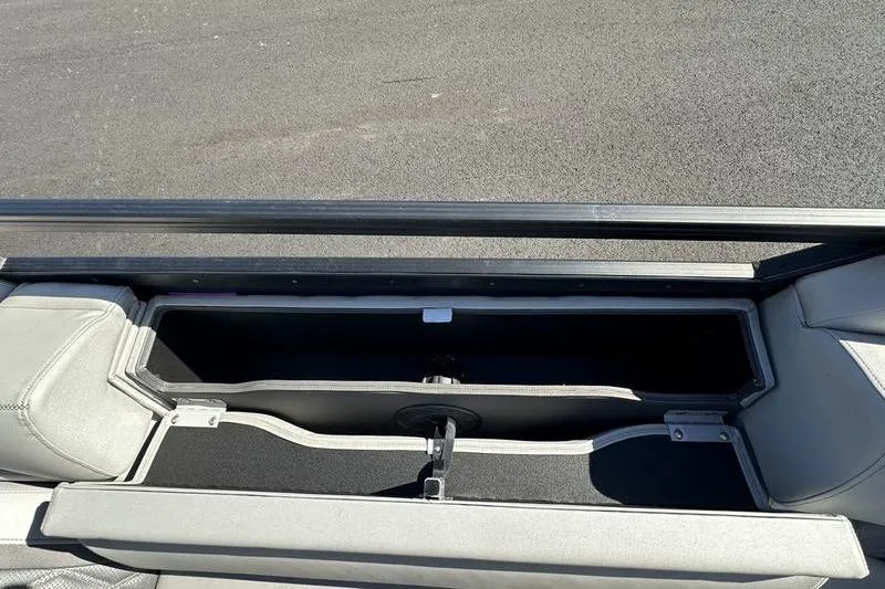 Slide: The Image of Open storage compartment in 2021 Bennington 24 RTFB boat, featuring sleek design and ample space. - 9