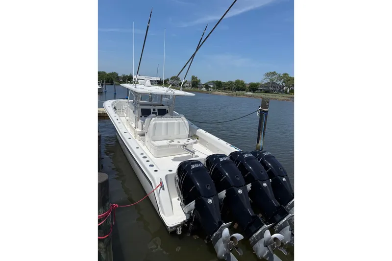 The Image of 2018 Invincible 42 Open Fisherman boat docked with four powerful engines. - 0