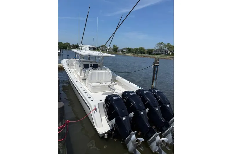 Slide: The Image of 2018 Invincible 42 Open Fisherman boat docked with four powerful engines. - 11