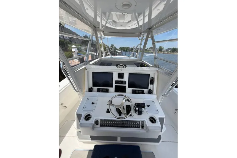 Slide: The Image of 2018 Invincible 42 Open Fisherman boat cockpit with navigation controls and screens. - 14
