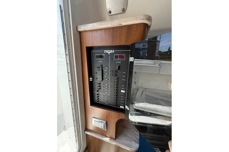 Slide: The Image of Electrical panel on a 2018 Invincible 42 Open Fisherman boat, featuring switches and voltage display. - 18