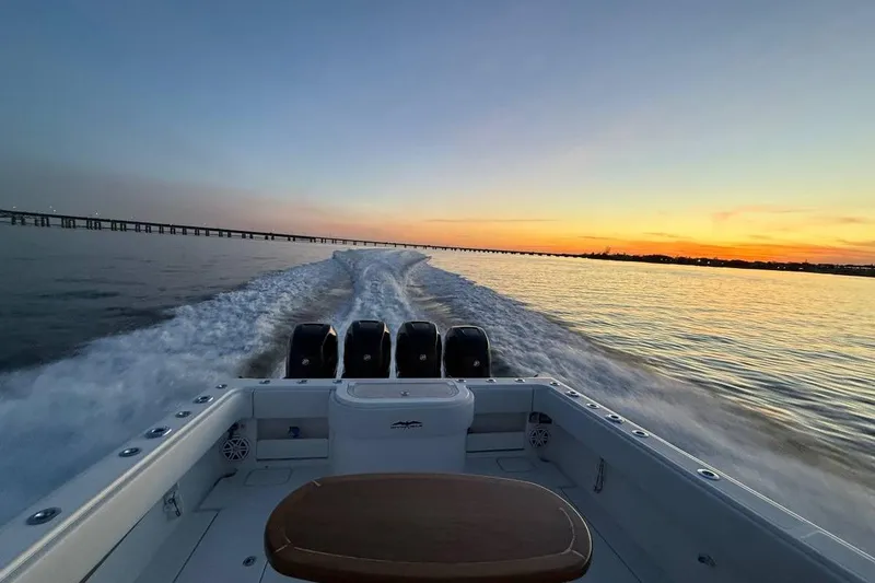 Slide: The Image of 2018 Invincible 42 Open Fisherman cruising at sunset, leaving a wake behind. - 21