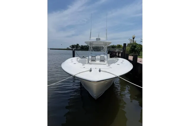 Slide: The Image of 2018 Invincible 42 Open Fisherman boat docked on calm water. - 4