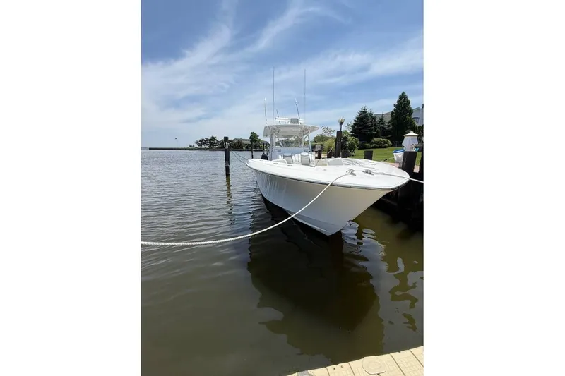 Slide: The Image of 2018 Invincible 42 Open Fisherman boat docked on a sunny day. - 5