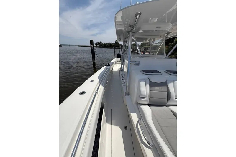 Slide: The Image of 2018 Invincible 42 Open Fisherman boat docked by the water. - 9