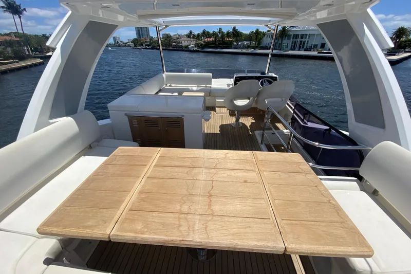 Slide: The Image of Luxurious 2017 Sunseeker Manhattan 52 yacht interior with wooden table and seating area. - 10