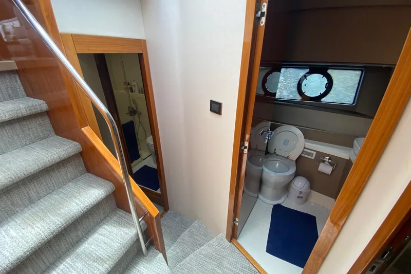 Slide: The Image of Interior of 2017 Sunseeker Manhattan 52 yacht, featuring stairs and a compact bathroom. - 21