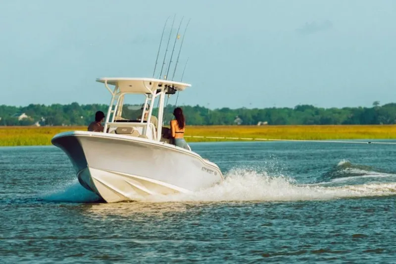 The Image of 2026 Key West 219 FS boat cruising on a scenic waterway. - 1