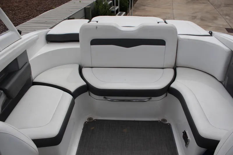 Slide: The Image of 2015 Chaparral 226 SSi boat interior with white and black seating arrangement. - 11