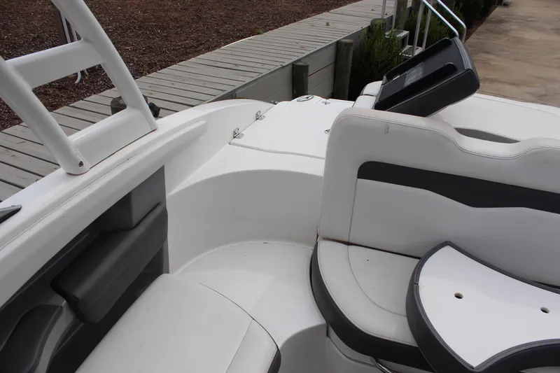 Slide: The Image of 2015 Chaparral 226 SSi boat interior with white seating and deck details. - 12