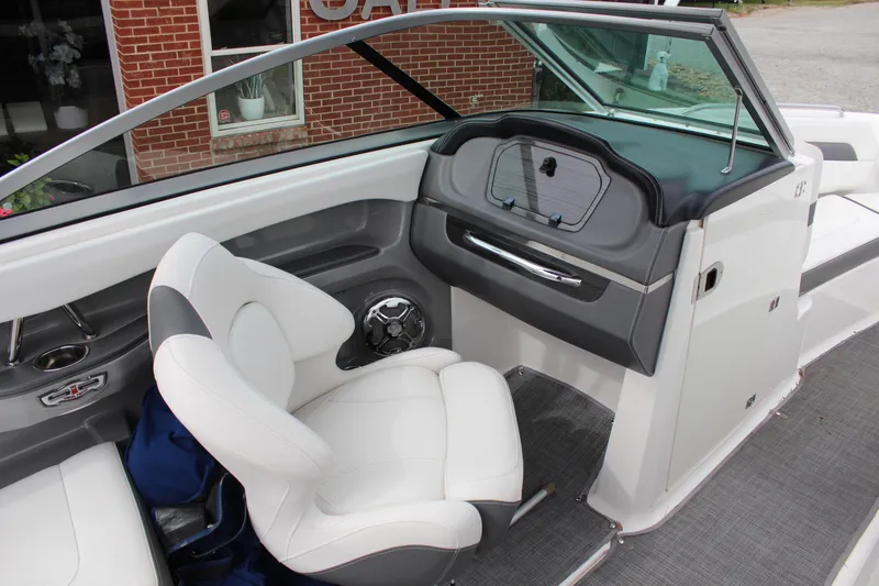 Slide: The Image of 2015 Chaparral 226 SSi boat interior with white seating and dashboard view. - 13