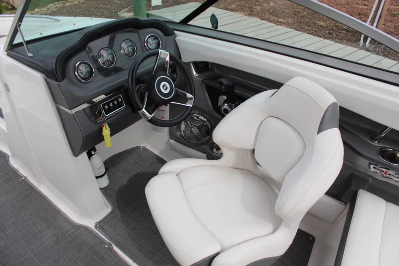 Slide: The Image of Interior view of 2015 Chaparral 226 SSi boat cockpit with steering wheel and white seat. - 14