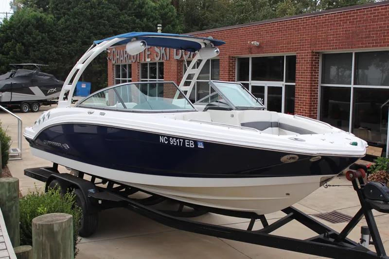 Slide: The Image of 2015 Chaparral 226 SSi boat on trailer, parked outside a brick building. - 17