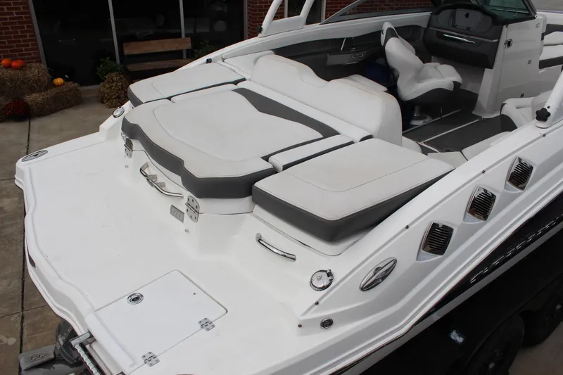 Slide: The Image of 2015 Chaparral 226 SSi boat with white and gray seating, sleek design, and modern dashboard. - 6