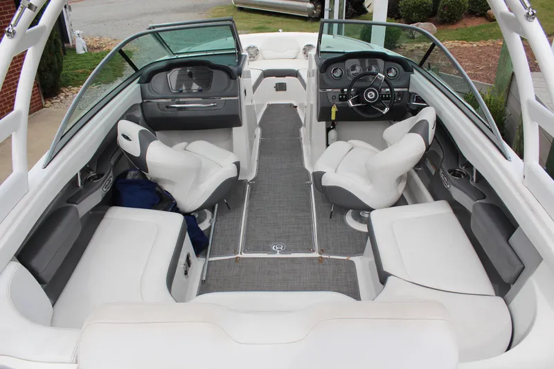 Slide: The Image of 2015 Chaparral 226 SSi boat interior with white seating and modern dashboard. - 7