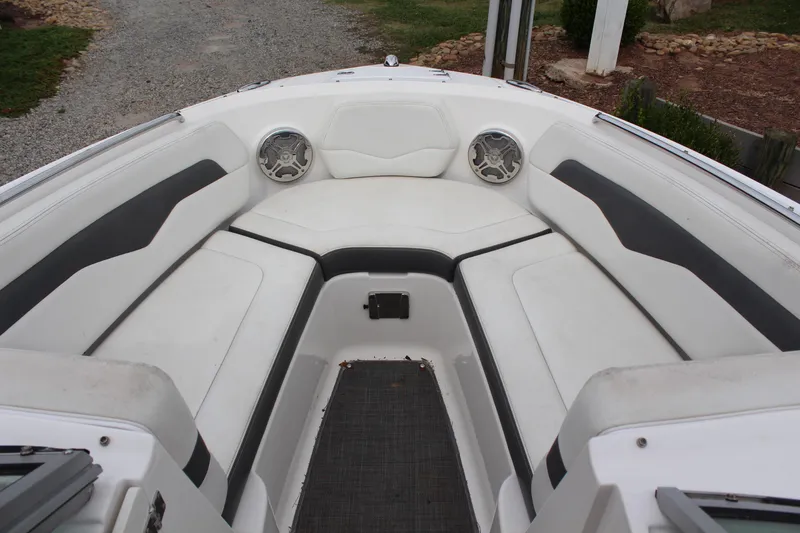 Slide: The Image of 2015 Chaparral 226 SSi boat interior with white and gray seating, featuring speakers. - 8