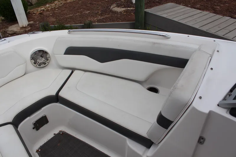 Slide: The Image of 2015 Chaparral 226 SSi boat interior with white and gray seating. - 9