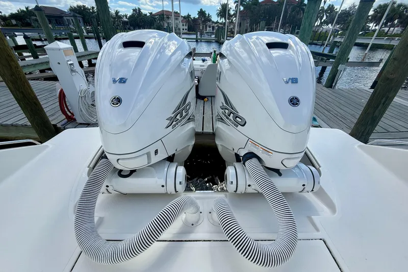 Slide: The Image of 2023 Pursuit S 358 Sport boat with twin Yamaha V8 outboard engines at a dock. - 10