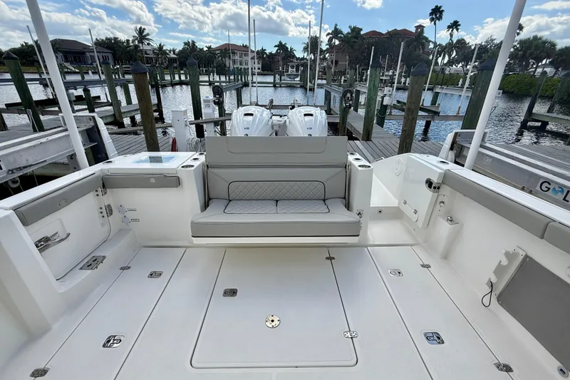 Slide: The Image of 2023 Pursuit S 358 Sport boat interior with seating and dock view. - 14