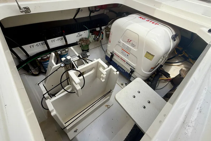 Slide: The Image of 2023 Pursuit S 358 Sport boat engine compartment with generator and equipment. - 19