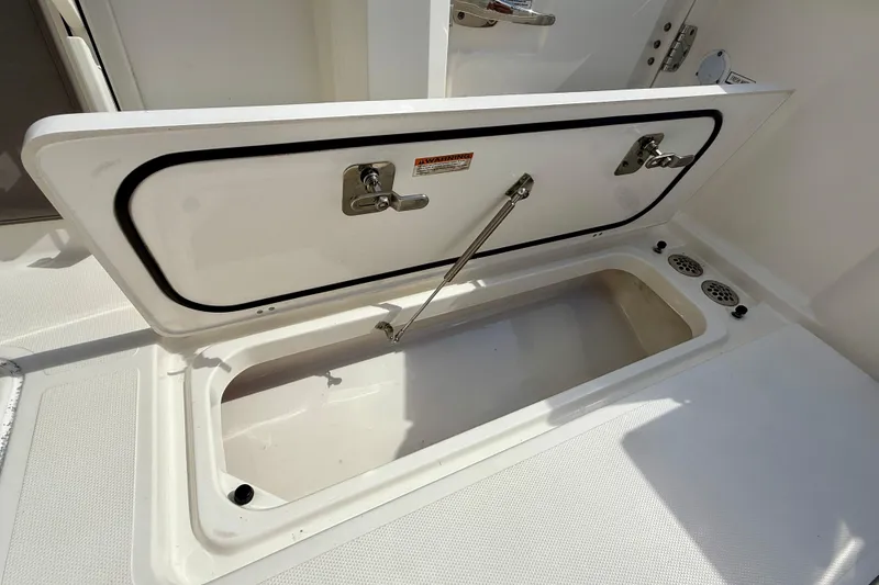 Slide: The Image of Open storage compartment on 2023 Pursuit S 358 Sport boat. - 20