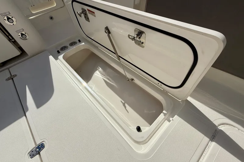 Slide: The Image of Open storage compartment on 2023 Pursuit S 358 Sport boat deck. - 21