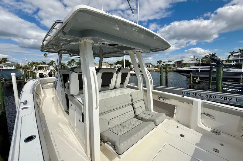 Slide: The Image of 2023 Pursuit S 358 Sport boat docked, featuring sleek design and spacious seating. - 26