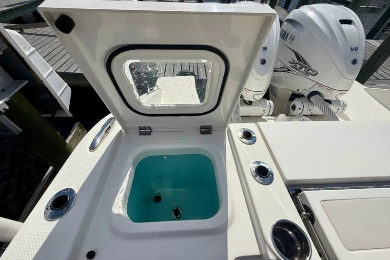 Slide: The Image of 2023 Pursuit S 358 Sport boat with open hatch and twin Yamaha engines. - 29